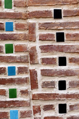 old historic brick wall with colorful ceramic