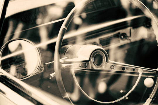 Detail of a classic american car with steering wheel and dashboard