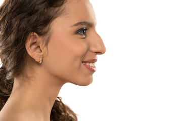 Profile portrait of a beautiful smiling young woman, a nose with a hump on white background