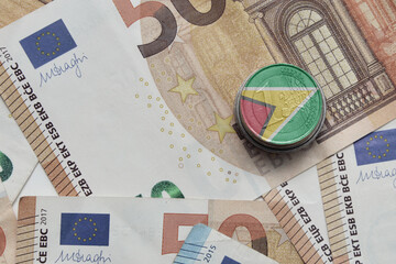 euro coin with national flag of guyana on the euro money banknotes background