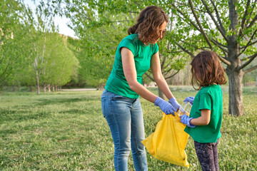 a girl with her mother collecting plastic from the field to take care of nature