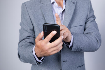 phone.men hand holding texting using mobile on sofa at home