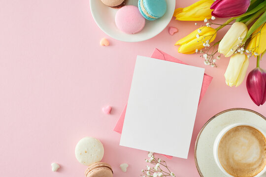 Mother's Day concept. Top view photo of postcard cup of coffee macaroons small hearts baubles bunch of colorful tulips and gypsophila flowers on pastel pink background with blank space