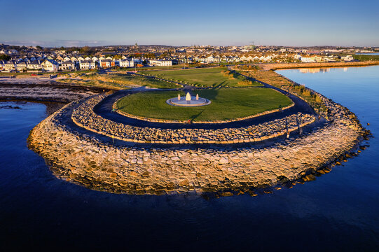 Aerial view on Famine Ship Memorial in Celia Griffin Memorial Park in Salthill area of Galway city, Ireland. Dense residential area in the background.