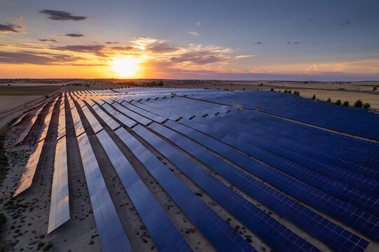 Aerial view of the solar power plant with sunset reflection on the solar panels. Solar park is a ground-mounted solar project which the company installed 138000 panels, Renewable, Solar Energy, Spain
