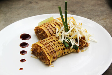 Pad Thai - Thai fusion food - Stir fried rice noodles on white ceramic plate