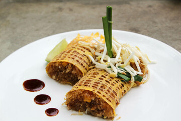 Pad Thai - Thai fusion food - Stir fried rice noodles on white ceramic plate