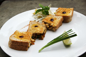 Pad Thai - Thai fusion food - Stir fried rice noodles on white ceramic plate