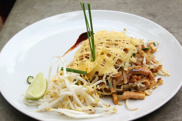 Pad Thai - Thai fusion food - Stir fried rice noodles on white ceramic plate