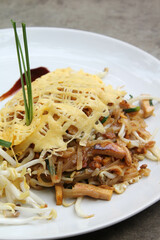Pad Thai - Thai fusion food - Stir fried rice noodles on white ceramic plate