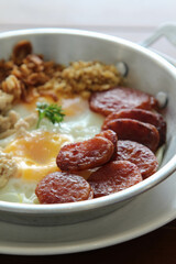 Vietnam food, Pan fried egg serve with sausage and pork on wooden table