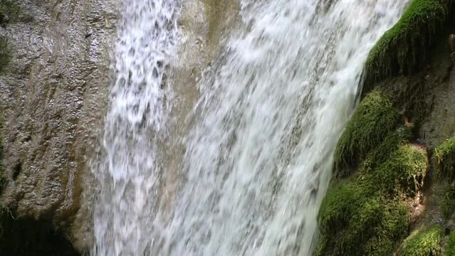 Waterfall pouring close-up in slow motion