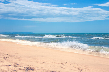 Fototapeta na wymiar Sea coast with wave and sandy shore on a summer day. Black Sea, resorts of the Krasnodar Territory