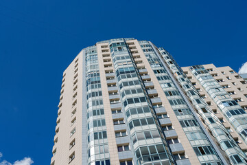 Fototapeta na wymiar Multi-storey apartment building with many windows
