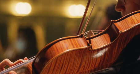 Cinematic Closeup on a Violin Beig Played by a Musician on a Stage. Professional Symphony Orchestra...