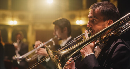 Cinematic Closeup of a Male Trumpet Player Reading a Music Sheet and Playing his Instrument....