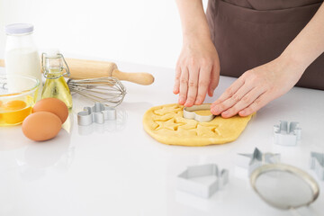 Making for homemade biscuits. On the table is dough and a set of cookie molds with other kitchen equipment. Cute baby cookies in the shape of  a heart and a tree. Cooking with baking tools. Copy Space