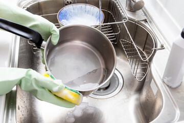 Woman wash dish in the kitchen