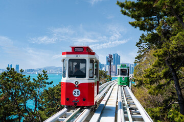 Colorful Sky Capsule train, a landmark seaside railway route, a destination where tourists take a...