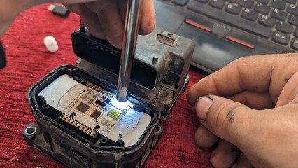 Inspection of the opened car control unit under an electronic endoscope