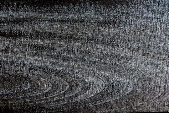 Gray surface of a pine board with traces of processing.
