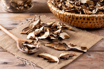 Arrangement of Forest Dried Mushrooms on Wooden table. Focus on Foreground