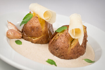 Baked potatoes with parmesan and mushroom sauce.