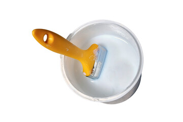 Yellow brush over a bucket of white paint, isolated on a white background. A jar of white enamel...