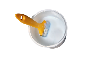 Yellow brush over a bucket of white paint, isolated on a white background. A jar of white enamel stands on the floor