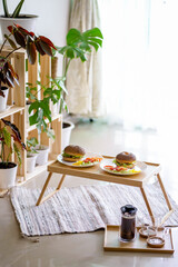 Healthy western breakfast, Sandwich on a Bagel with egg and bacons with morning sunlight indoor garden background. Picnic breakfast