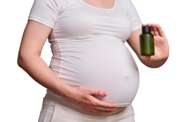 Bottle with body oil in pregnant woman, studio shot isolated on a white background
