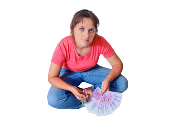 Euros and dollars under the feet of the woman with the keys to the new flat, isolated on a white background. A woman sits on an empty floor with money in her hands.