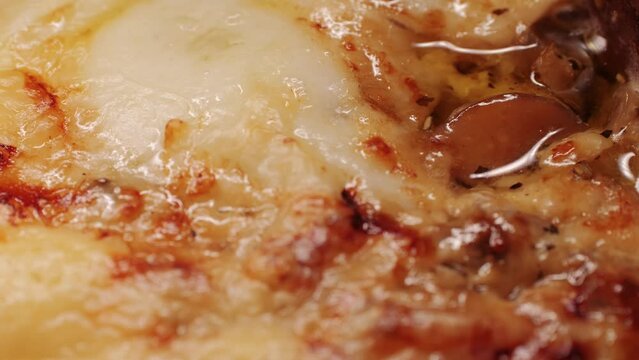 Melted cheese close up, melt pizza with cheese baking on tray in electric oven - macro, close up. Italian cuisine, homemade bakery, cooking food. 