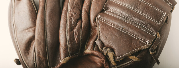 Old brown leather texture of vintage baseball glove for sport banner background.