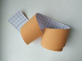 kinesiology tape on white background. Physiotherapy and therapeutic tape for wrist pain, aches and tension. elastic therapeutic tape. adhesive tape and alternative medicine

