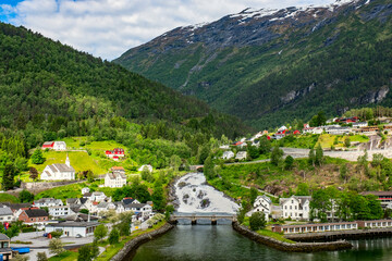 Fototapeta na wymiar Panoramic view of waterfall in Hellesylt, a small town at the entrance to Geirangerfjord, Norway. View from open deck of cruise ship.