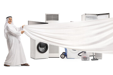 Arab man in traditional robe holding a white piece of cloth in front of home electrical appliances