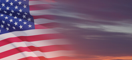 Obraz premium United States of America flag on sky at sunset or sunrise background.