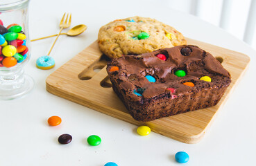 Delicious and colorful cookie and chocolate brownie in a white table