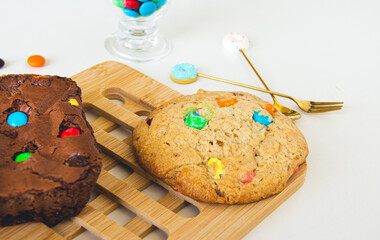 Delicious and colorful cookie and chocolate brownie in a white table
