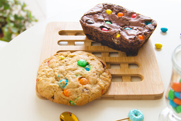 Delicious and colorful cookie and chocolate brownie in a white table