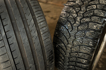 Winter studded and summer car tires. Change of wheels according to the season