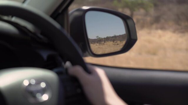 POV car driving on asphalt highway. Left side traffic. Savannah road in Africa.