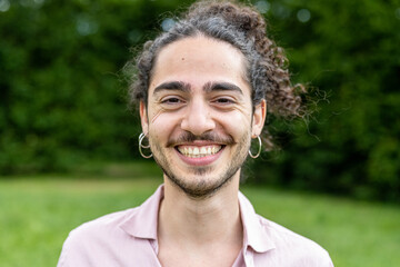 Portrait of a young man with long hair and beard, man of Latin and Caucasian origins