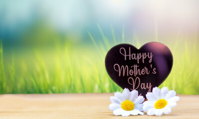 Happy mothers day card with bright bokeh fresh green grass background and white daisy flowers,...