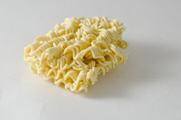 Uncooked instant noodles cut in half isolated on a white background