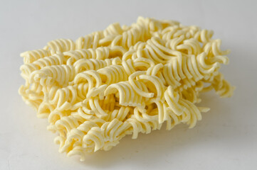 Uncooked instant noodles cut in half isolated on a white background