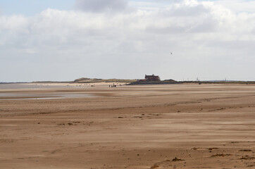 Distant figures on a beach in Norfolk, UK
