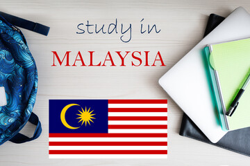 Fototapeta na wymiar Study in Malaysia. Background with notepad, laptop and backpack. Education concept.