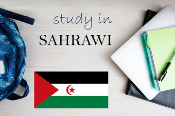 Study in Sahrawi. Background with notepad, laptop and backpack. Education concept.